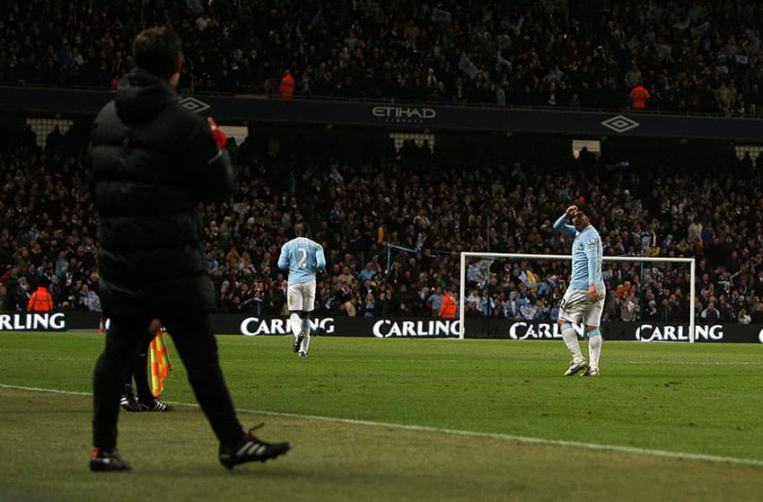 Neville flips off Tevez in a Carling Cup match