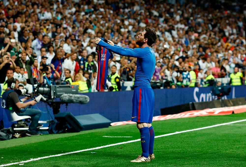 Messi shows Madrid supporters his own shirt with his own name on it after scoring a 93rd minute El Clasico winner
